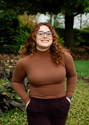 Autumn Eads smiles at the camera with her hands in her pockets.